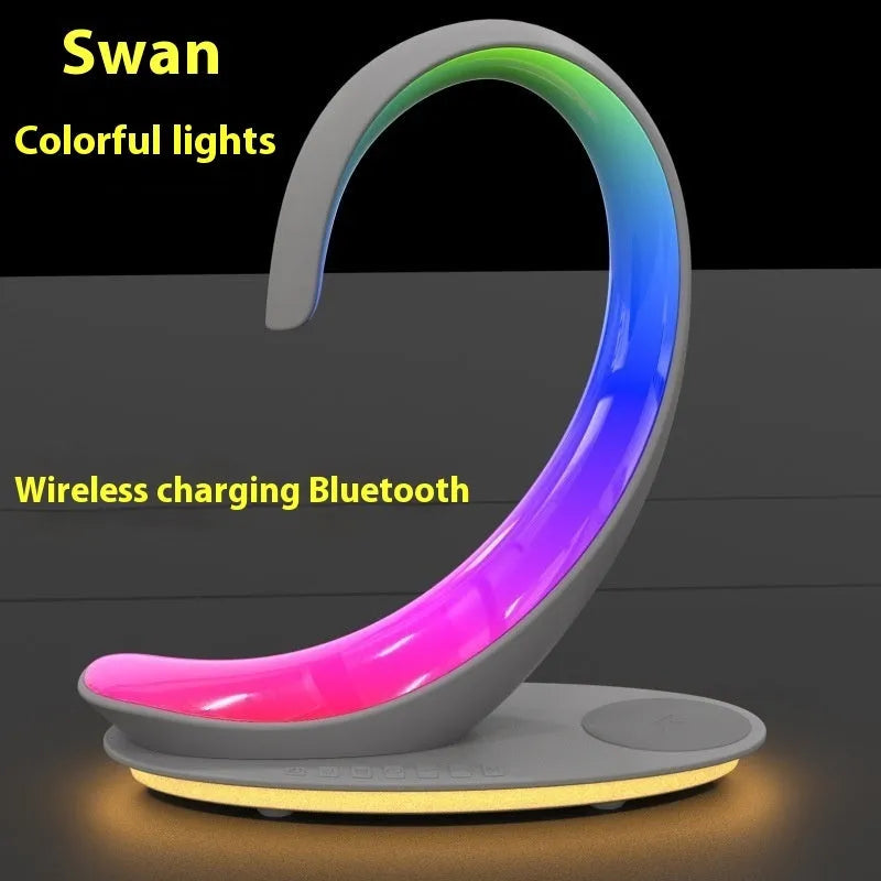 White swan-shaped desk lamp with wireless charging pad and Bluetooth speaker providing colourful ambient lighting