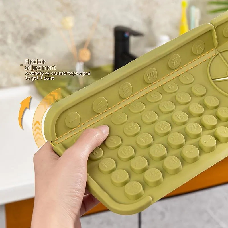 Cream TPR silicone faucet water draining pad measuring 42x14cm on a kitchen countertop