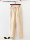 Men's beige pure cotton casual trousers with a drawstring waist on a hanger.
