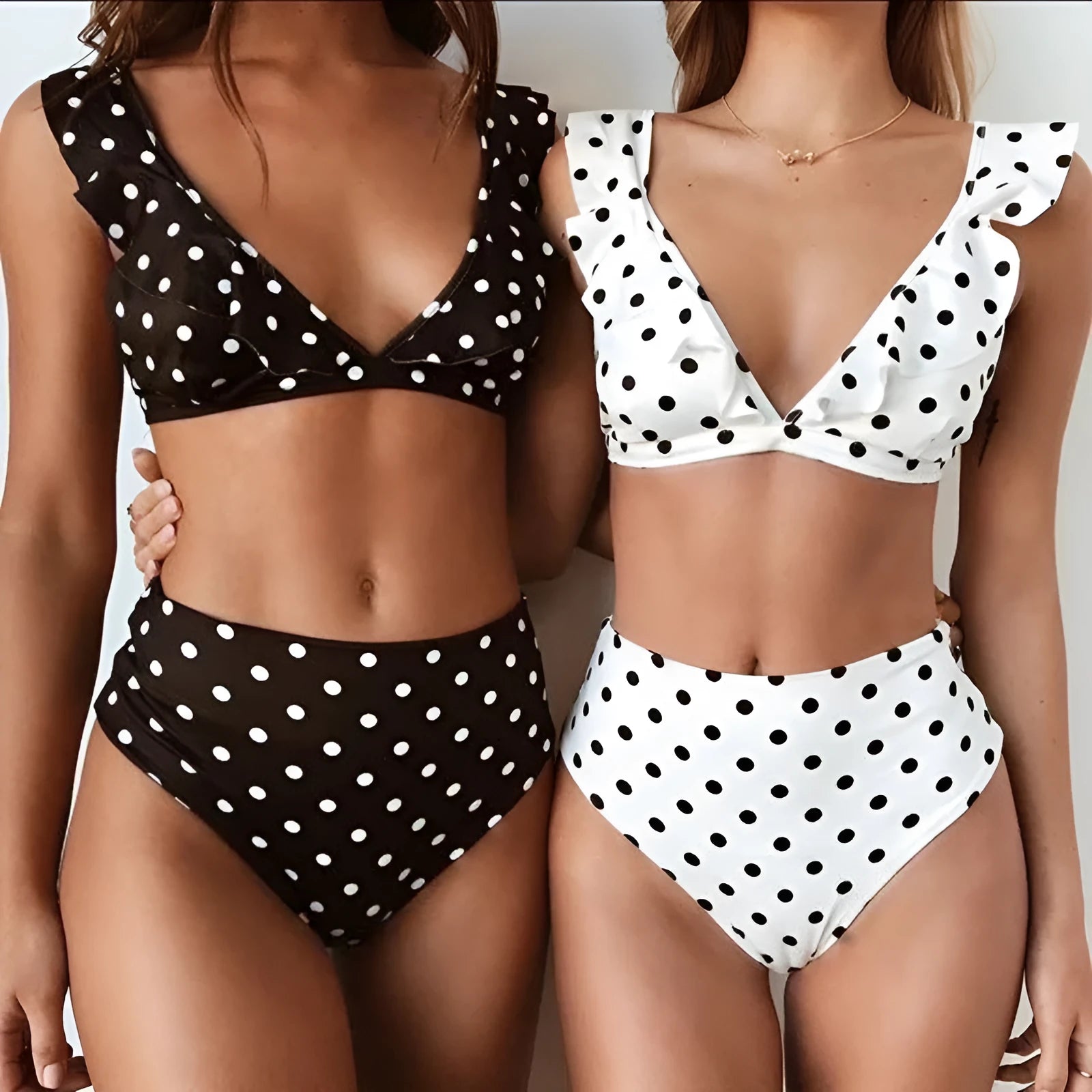 Women's black and white polka dot print bikini set with deep V-neck and ruffled detailing