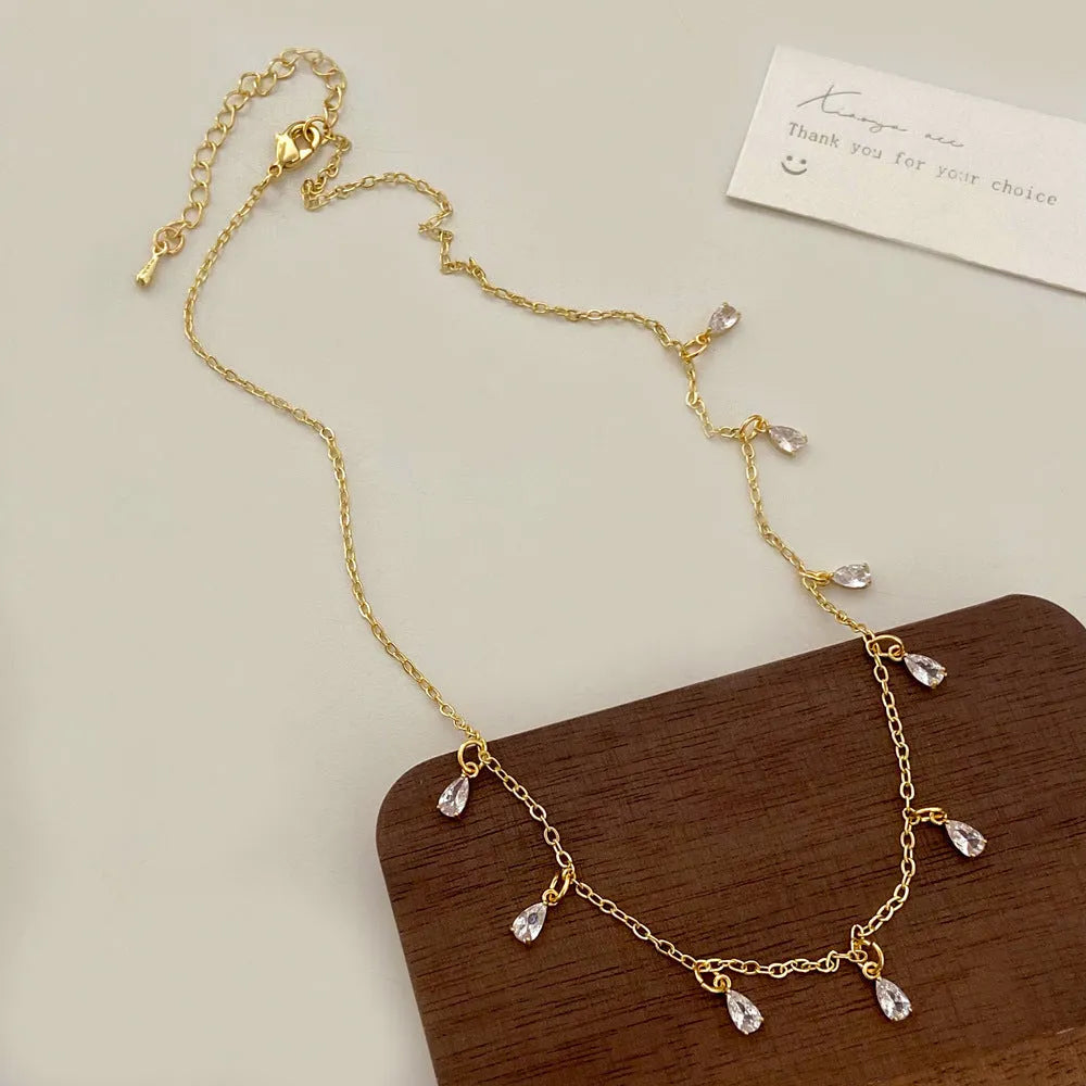 Women's zircon jewellery set with geometric pendant necklace, matching earrings and anklet in meteor shower design