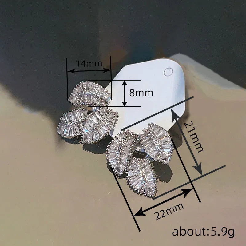 Leaf shaped zircon earrings in white gold colour with copper base and quadrilateral inlay