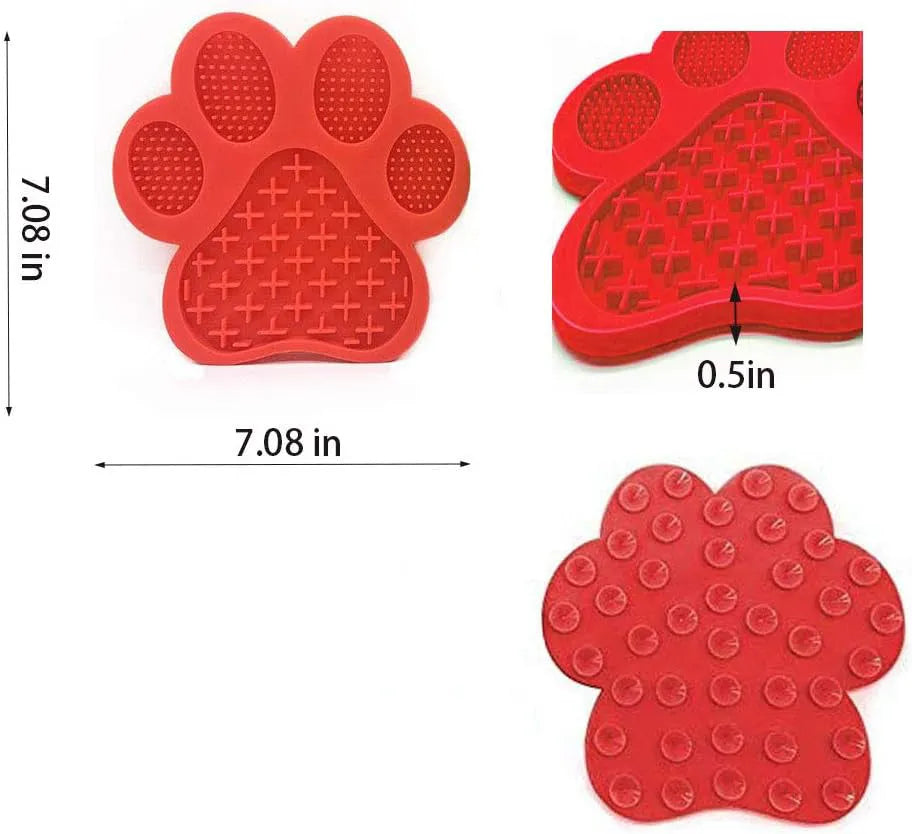 Blue bone-shaped silicone dog licking mat with suction cups on the back, placed on a tiled wall.