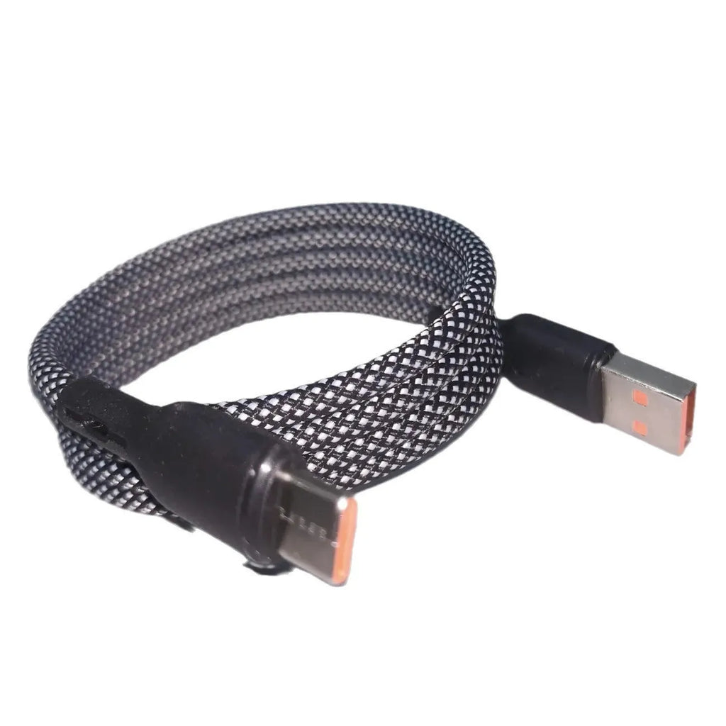 Magnetic woven data cable in black coiled beside a smartphone, showing Lightning and Type-C ends