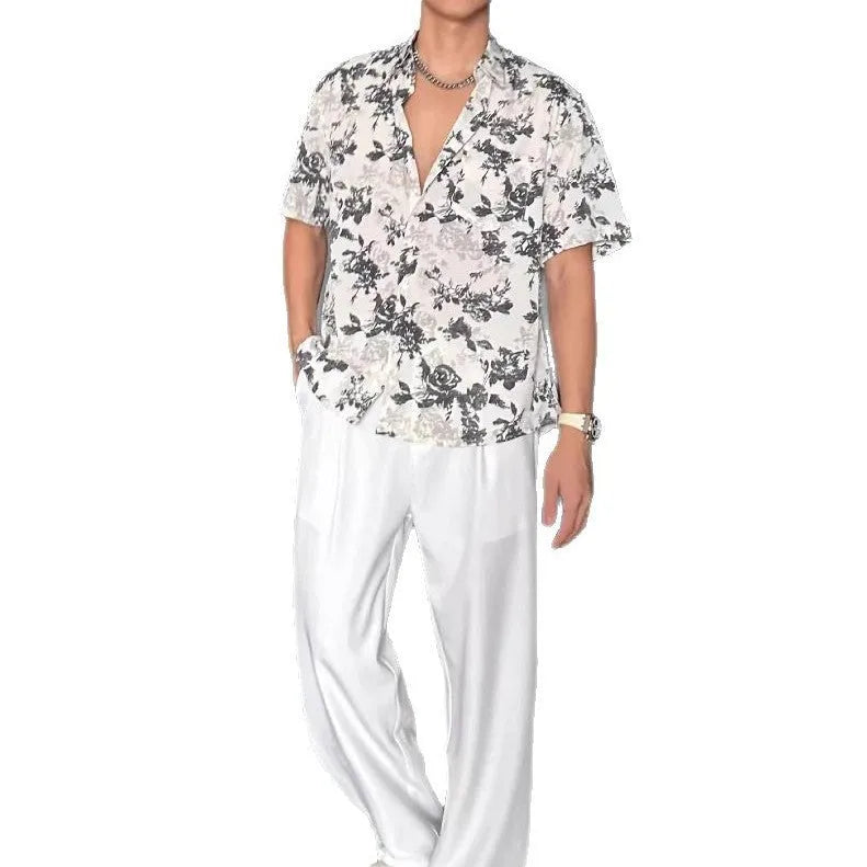 Black and white loose-fit floral printed short sleeve casual shirt on a hanger.
