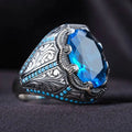 Geometric antique silver alloy couple ring with a blue zircon stone in a Grandmother Diamond setting.
