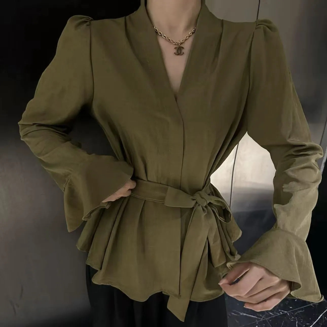 Women's black polyester shirt with a French-style irregular collar and long bell sleeves.
