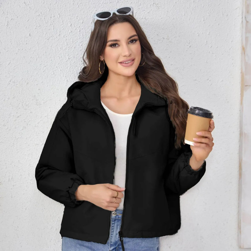 Women's loose-fit hooded shell jacket in grey, black, or purple colours, made from polyester fabric.
