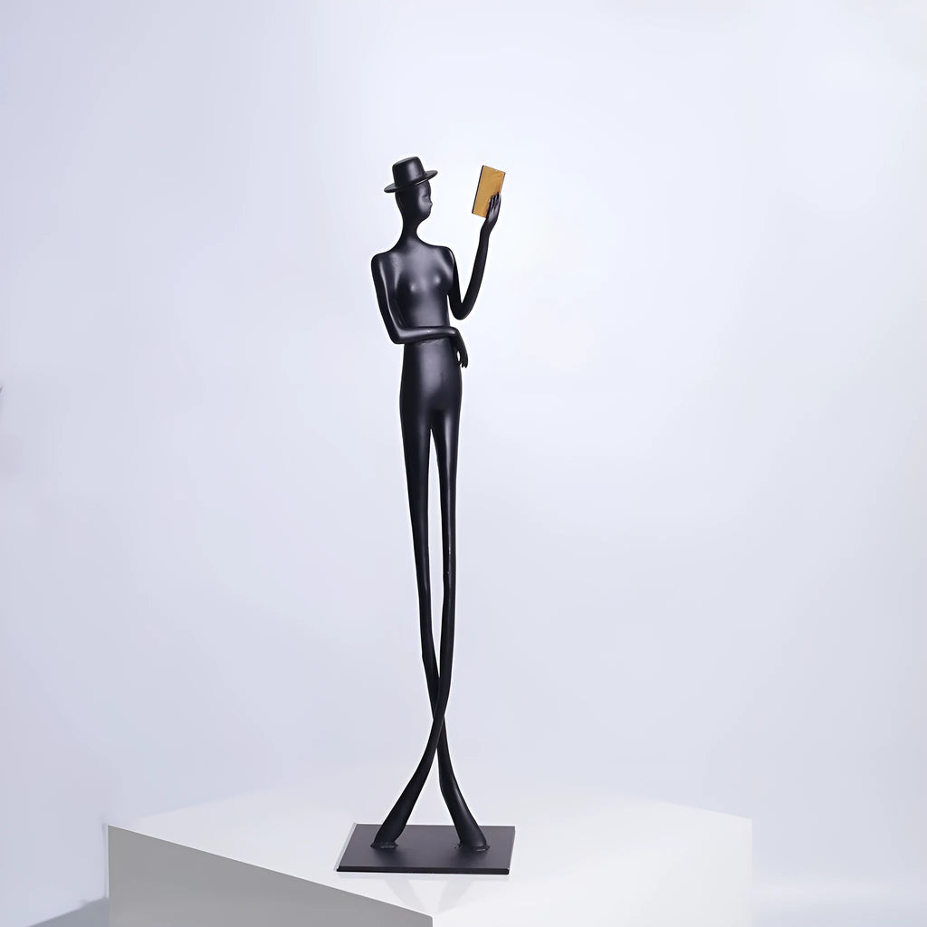 Black cast aluminium desktop sculpture of reading woman measuring 12x12x51cm
