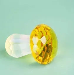 Colourful white crystal mushroom decorative craft in modern geometric style on a desk.