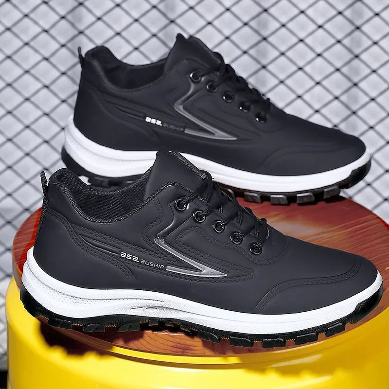 Black and grey waterproof leisure sports shoes with artificial PU upper and lace-up closure on a flat heel.