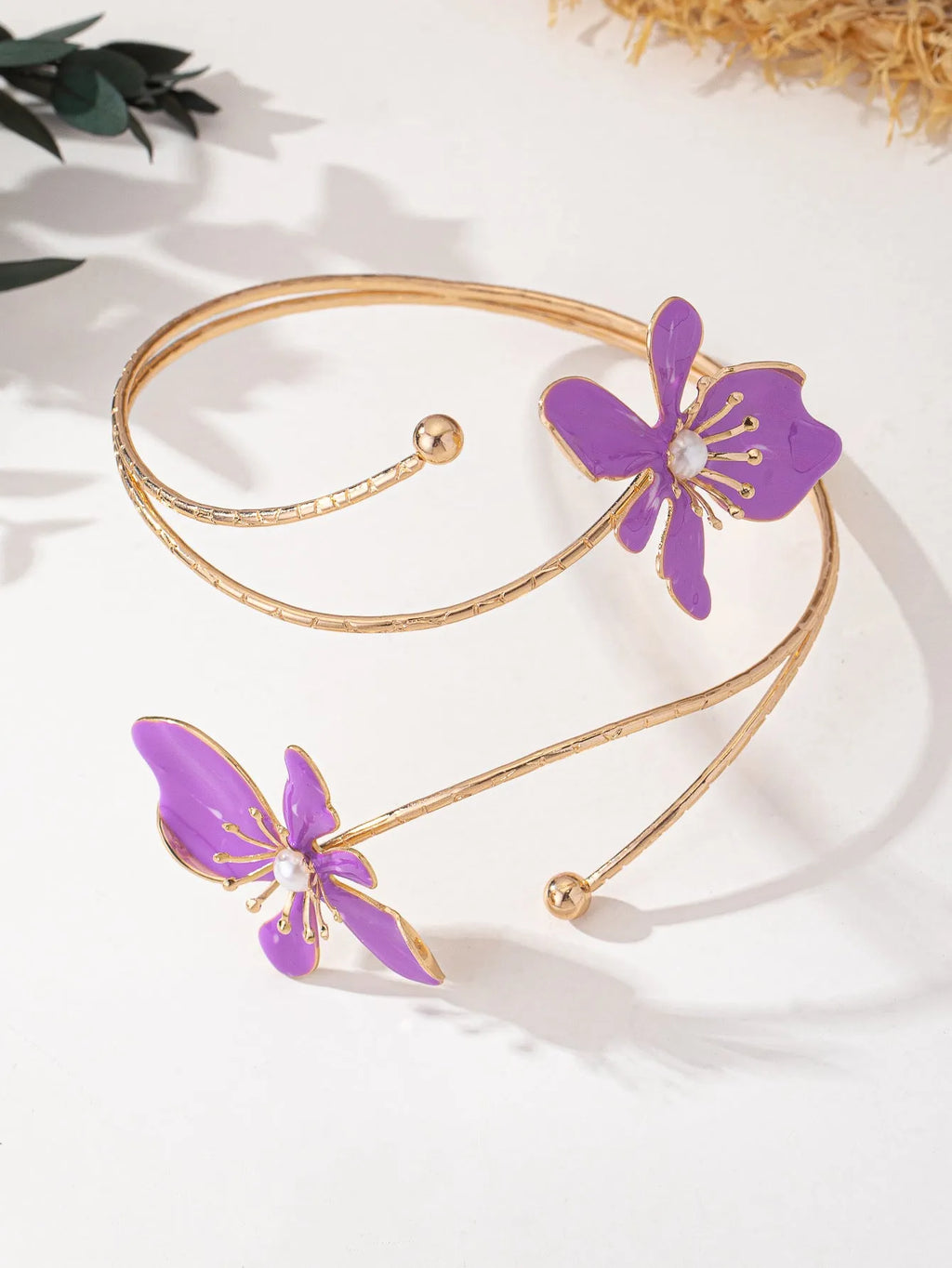 Close-up of a pink hollow patterned alloy armband for women's fashion.