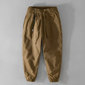 Men's cotton casual overalls in army green with a drawstring waist and tapered ankle bands.
