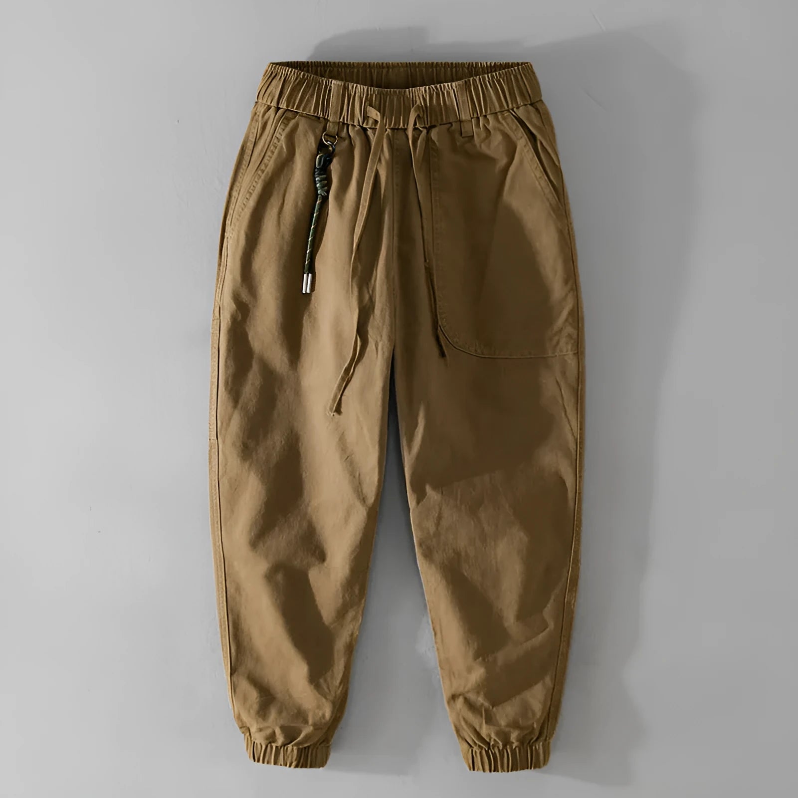Men's cotton casual overalls in army green with a drawstring waist and tapered ankle bands.
