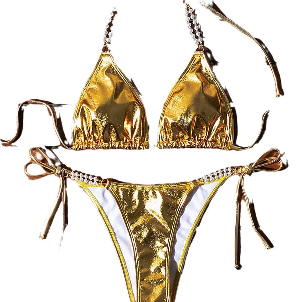 Gold bronzing effect women's halter neck bikini with lace-up back and pearl chain detail on mannequin