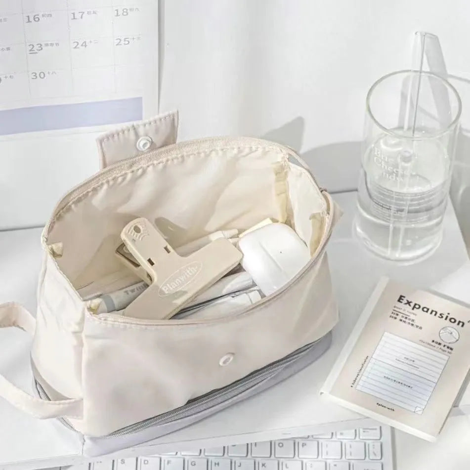 Folding double-layer student pencil case with two compartments and zippered closure in beige, blue, or navy blue colour
