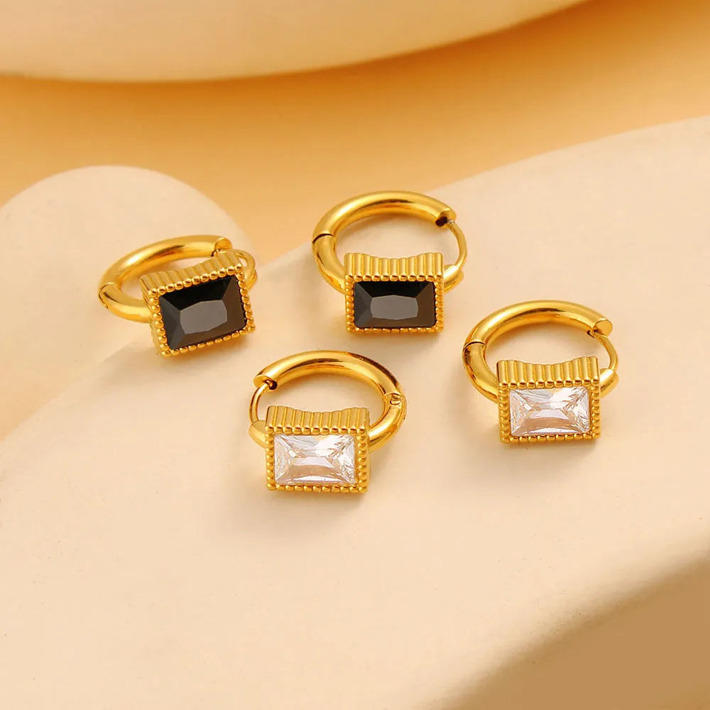 Square geometric stainless steel earrings with round ring details in white, black, or green.