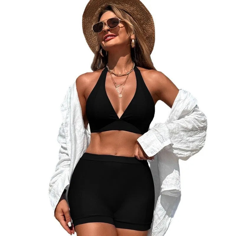 Women's black nylon split bikini swimsuit with polyester lining on a mannequin.