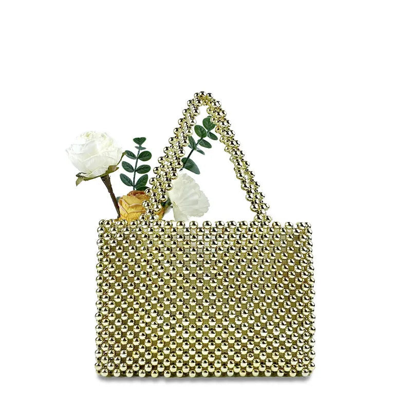 Gold hand-woven metal beads steamed crystal pearl bag, square vertical shape with double shoulder straps on a lady