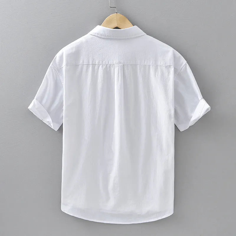 Men's light grey loose fit short-sleeved cotton cardigan shirt on a hanger.