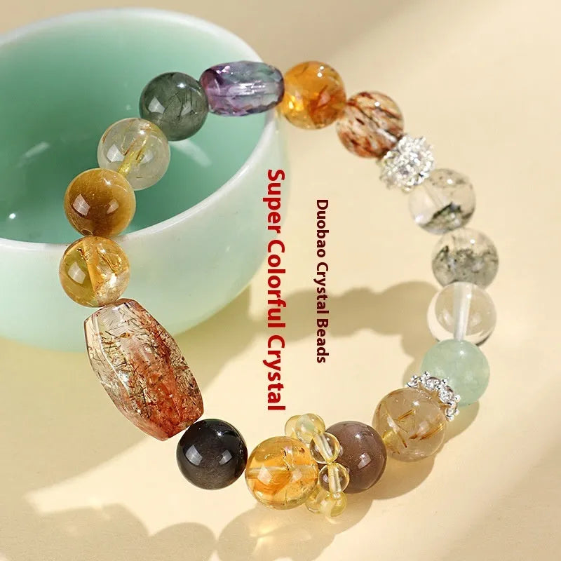 Natural Duobao crystal bead bracelet with black and gold beads on a woman's wrist.