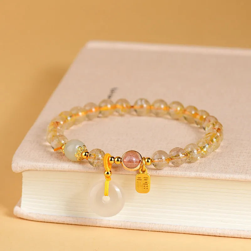 Gold rutilated quartz crystal bracelet with safety buckle and geometric blessing card pendant