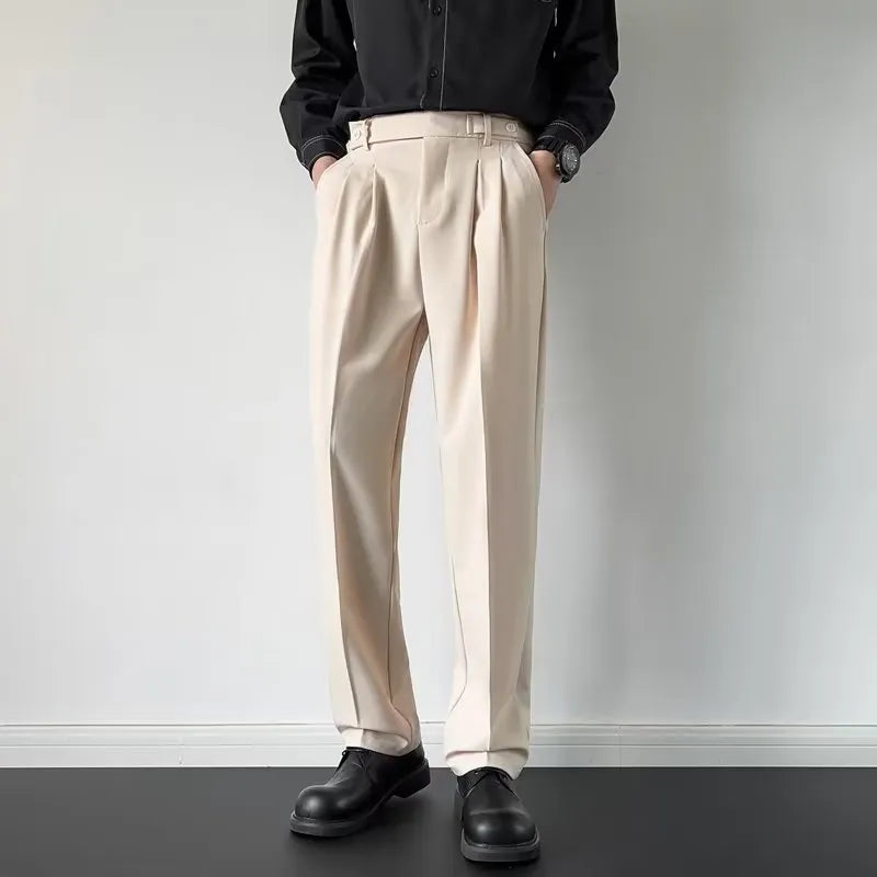 Men's apricot and black straight leg loose fit trousers on a hanger, showing the polyester fabric.