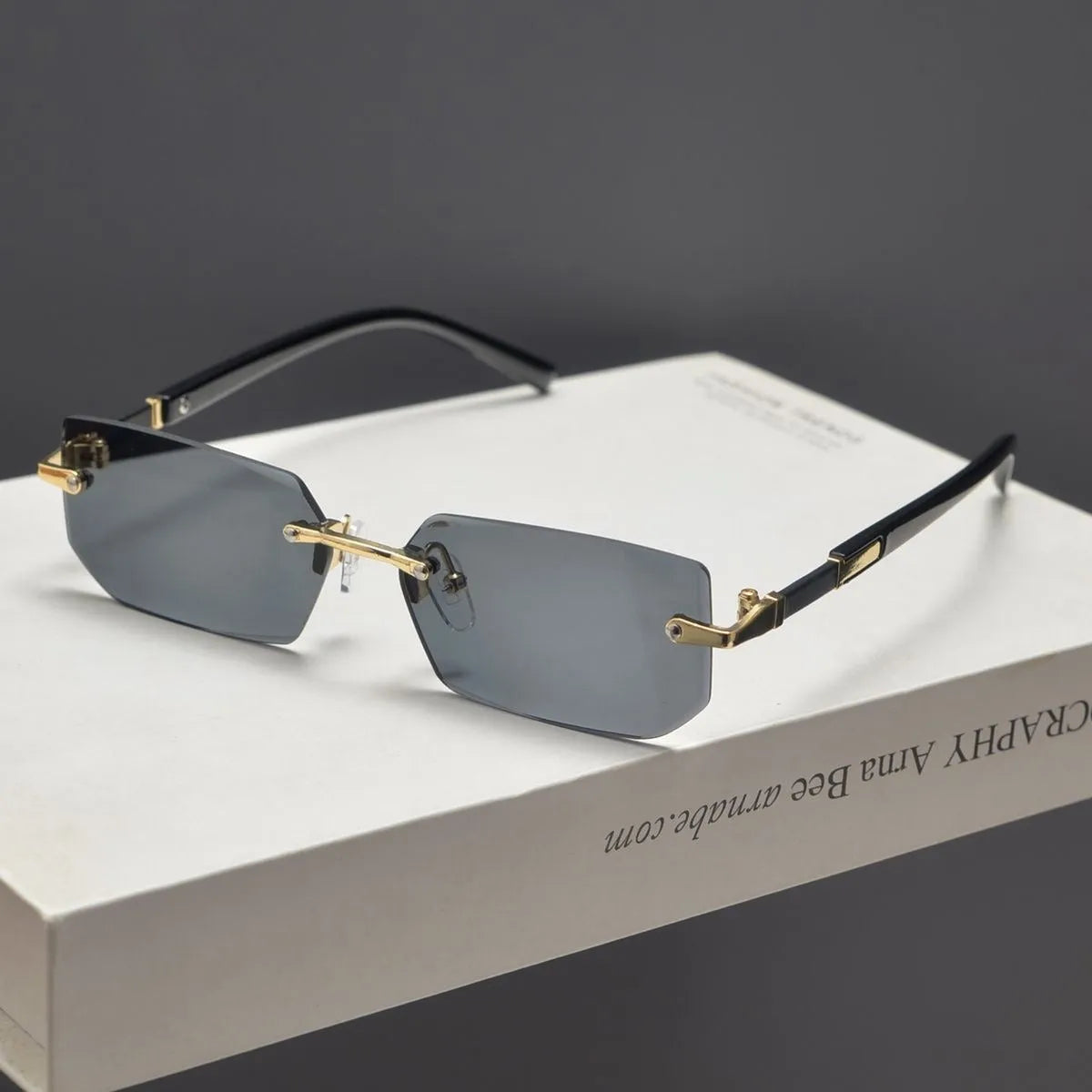 Unisex frameless water drop sunglasses in black, transparent, gold and gradient grey for sun protection and outdoor wear