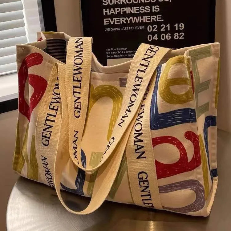 Large canvas tote bag with printed design, showing substantial capacity and casual styling