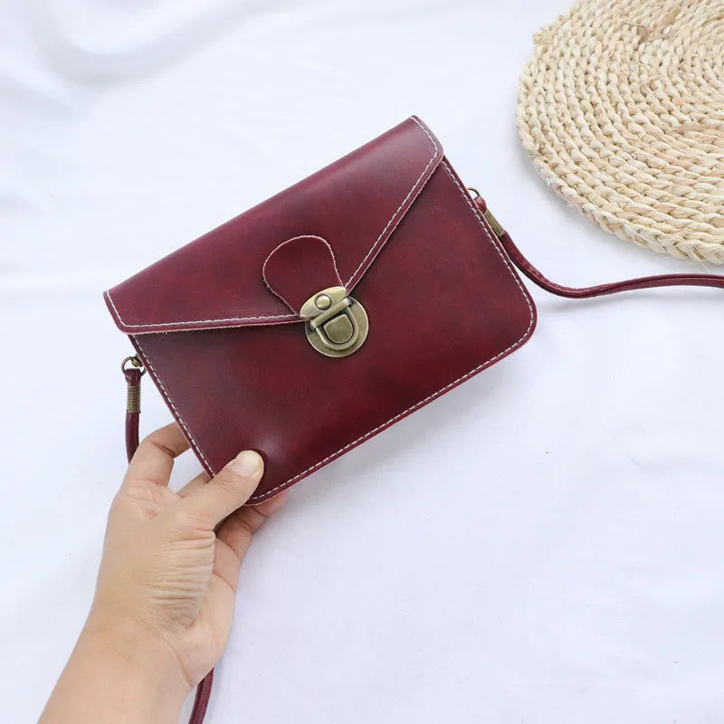 Retro soft surface messenger bag with lock closure showing wine red colour option