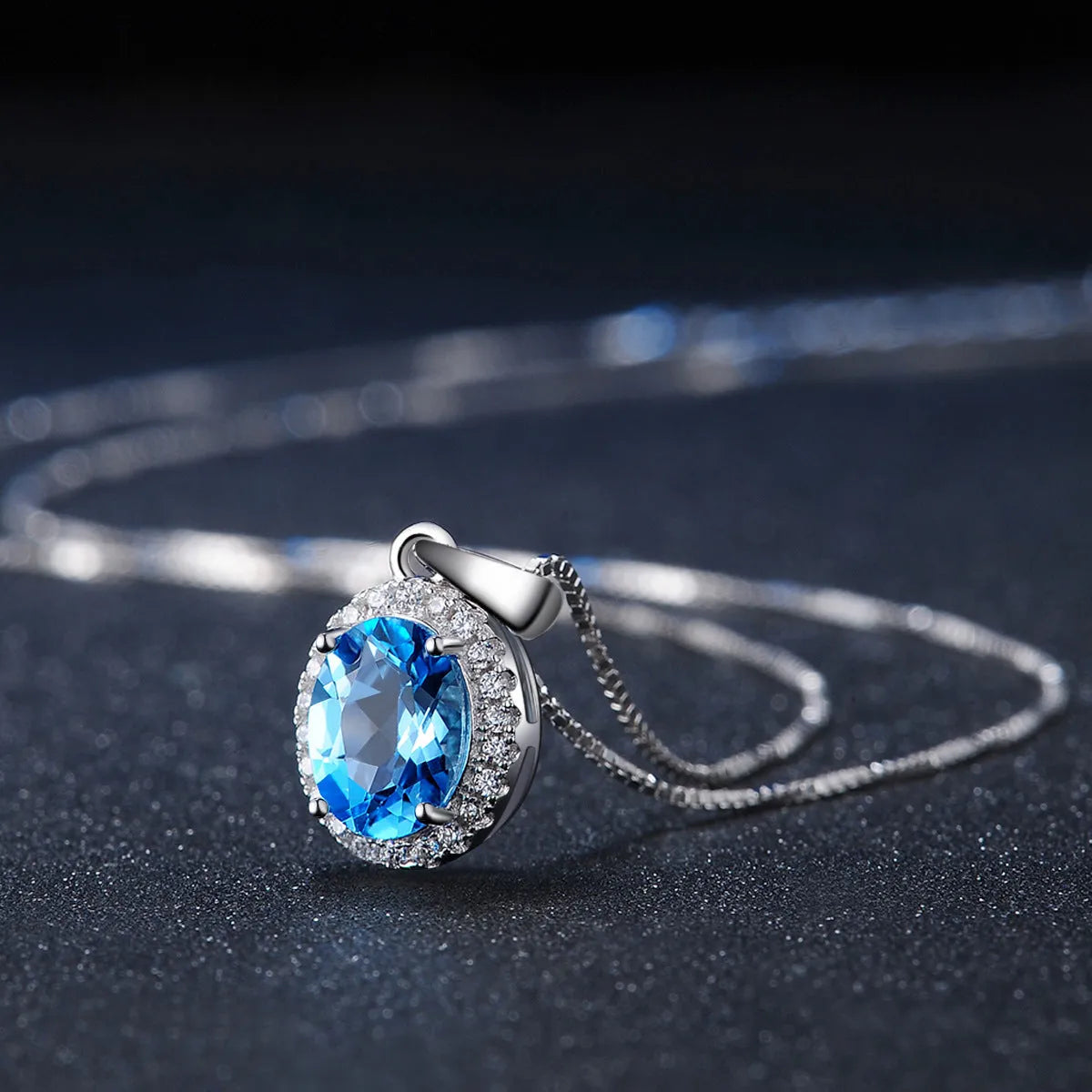 925 sterling silver four-piece jewellery set with blue topaz gems showing geometric earrings, ring, necklace, and pendant