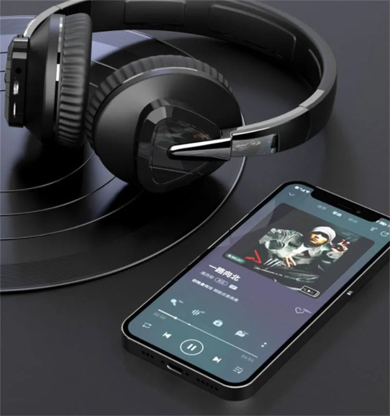 Black wireless over-ear headset with AUX cable and TF card slot, showing soft ear cups and control buttons.