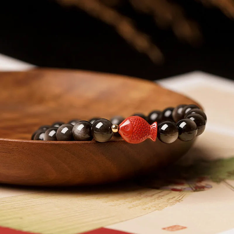 Natural obsidian round bead bracelet with a red cinnabar fungus charm, showing different bead size options.