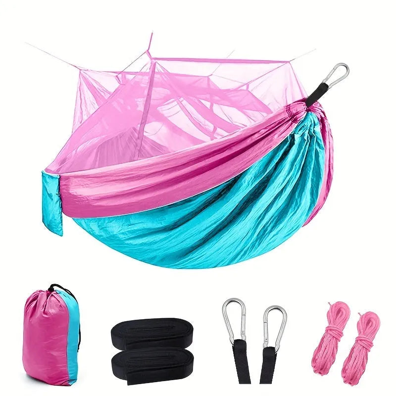 Portable double camping hammock with mosquito net and tree straps in outdoor setting