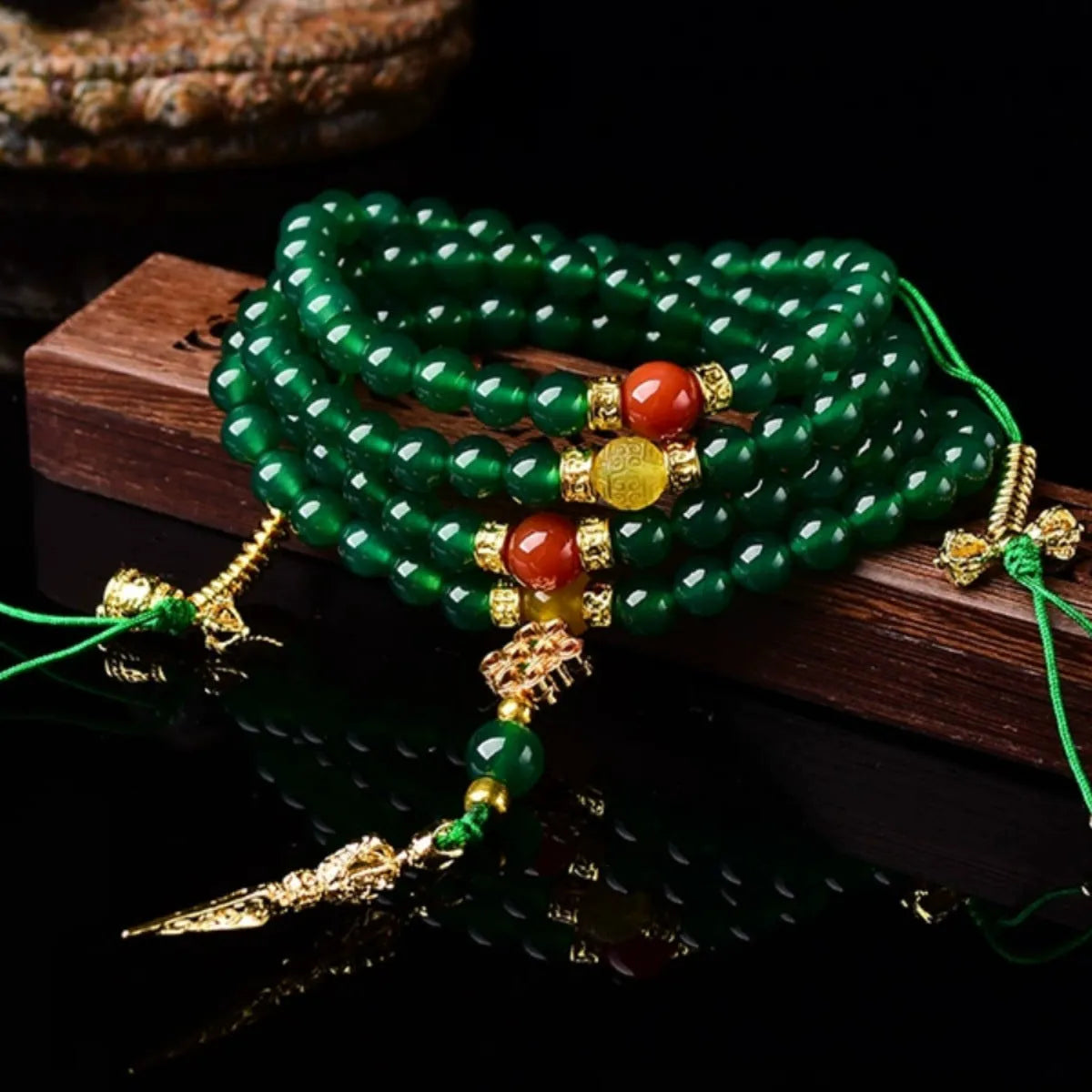 Close-up of a multi-circle green agate bracelet with natural stone beads on a wrist.