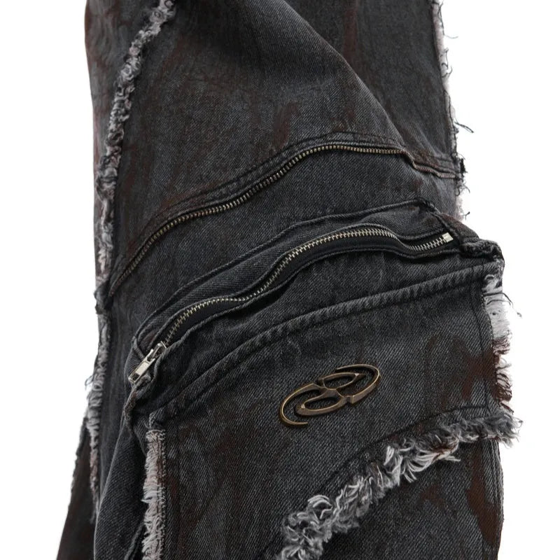 Black gradient distressed denim coat with padded shoulders and matching trousers on a hanger.