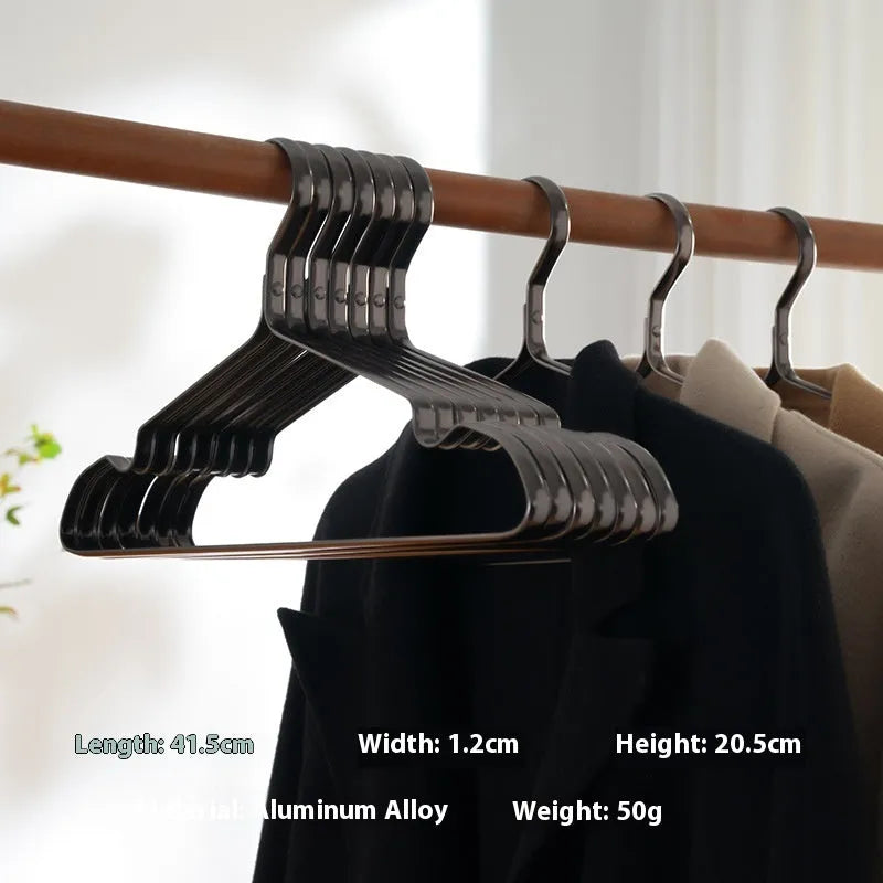 Modern elegant black clothes hanger with non-slip surface on a white background.