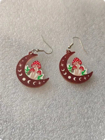 Brown wooden drop earrings with printed mushroom pattern on white background