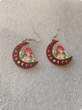Brown wooden drop earrings with printed mushroom pattern on white background