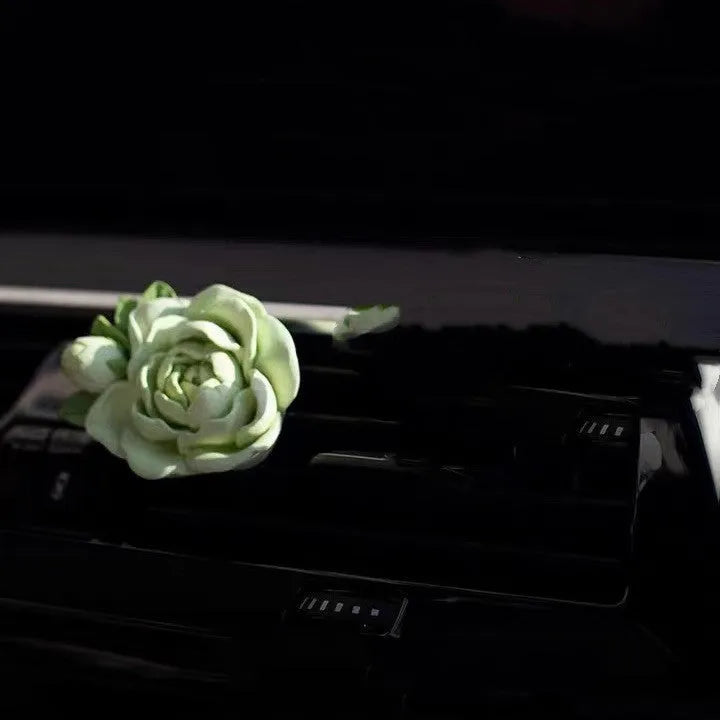 Jasmine-scented gypsum car air freshener ornament in off white or green, shown next to a 5ml essential oil bottle.