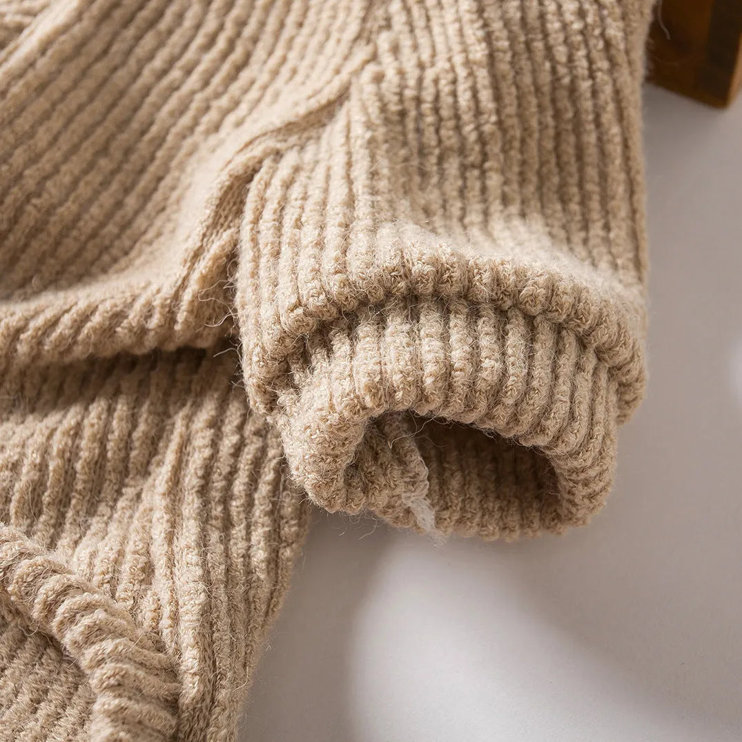 A brown knitted pullover sweater for a small dog on a mannequin.