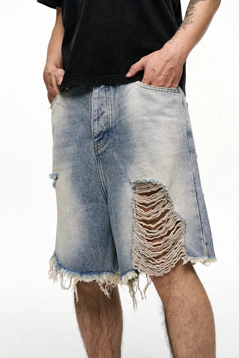 Light blue men's baggy denim shorts with a wide leg cut and mid waist on a plain background