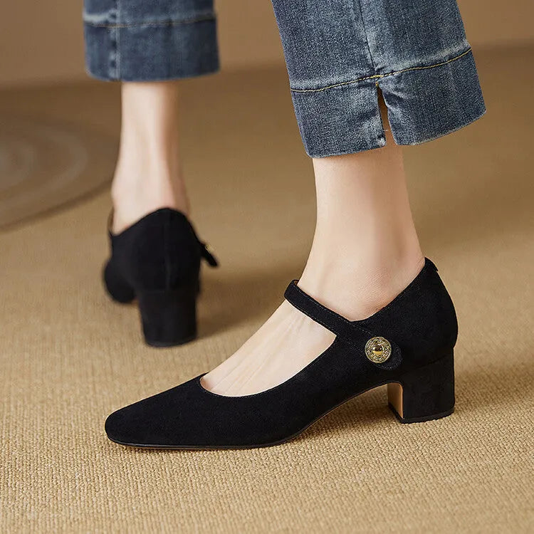 Women's black suede Mary Jane pumps with a chunky block heel and square toe on a plain background.