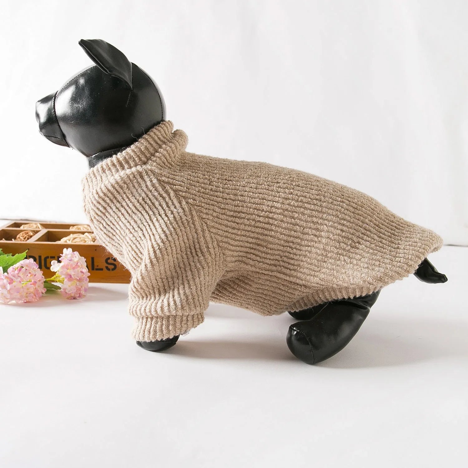 A brown knitted pullover sweater for a small dog on a mannequin.