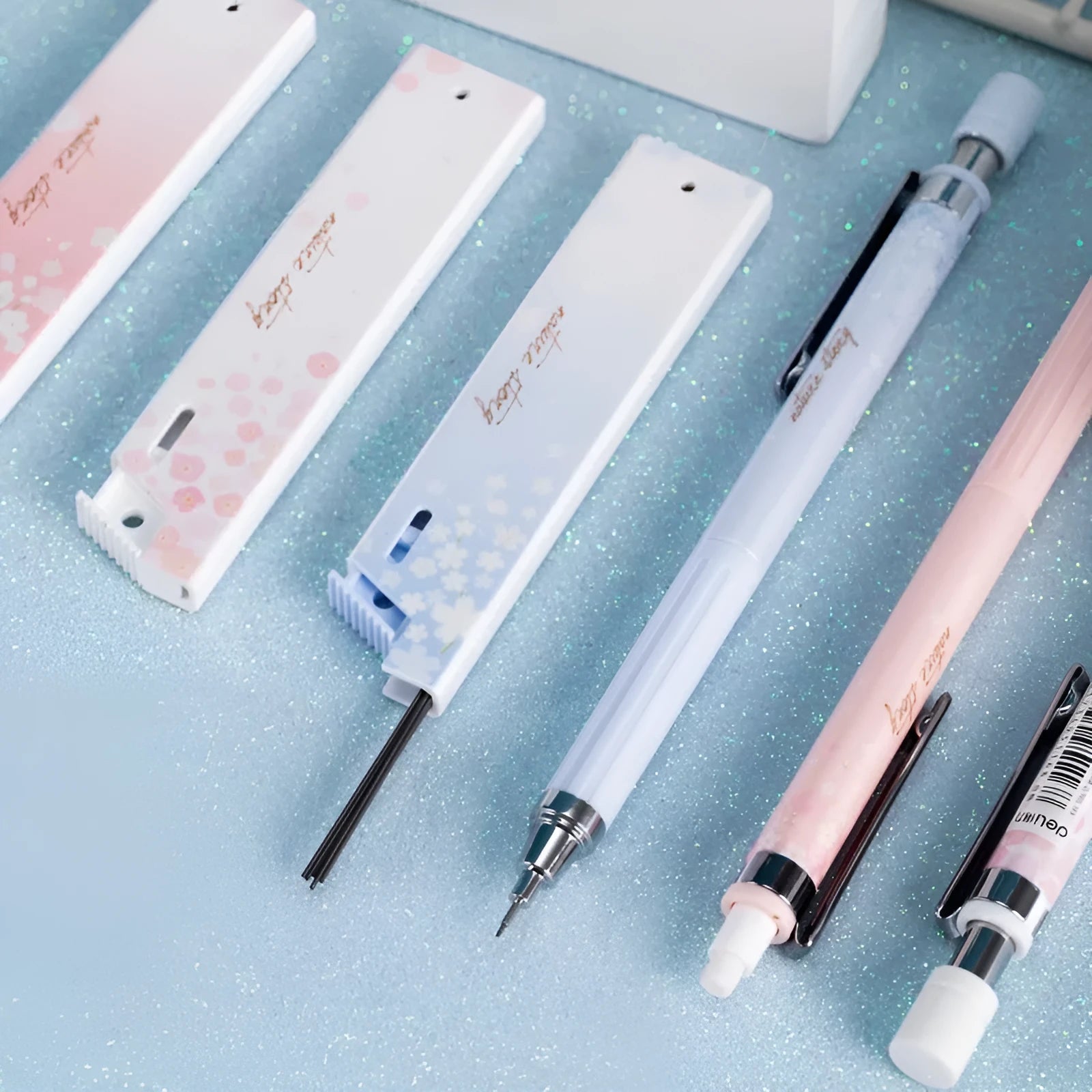 Three 0.5mm Sakura cartoon automatic pencils with HB refill boxes