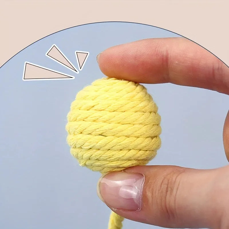 Fabric cat toy ball with rope attached in green, pink, purple, or yellow colours