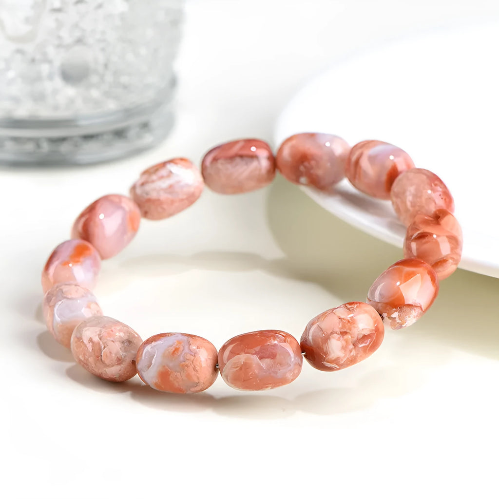 Natural cherry agate barrel bead bracelet with Ruyi charm showing 10x14mm beads