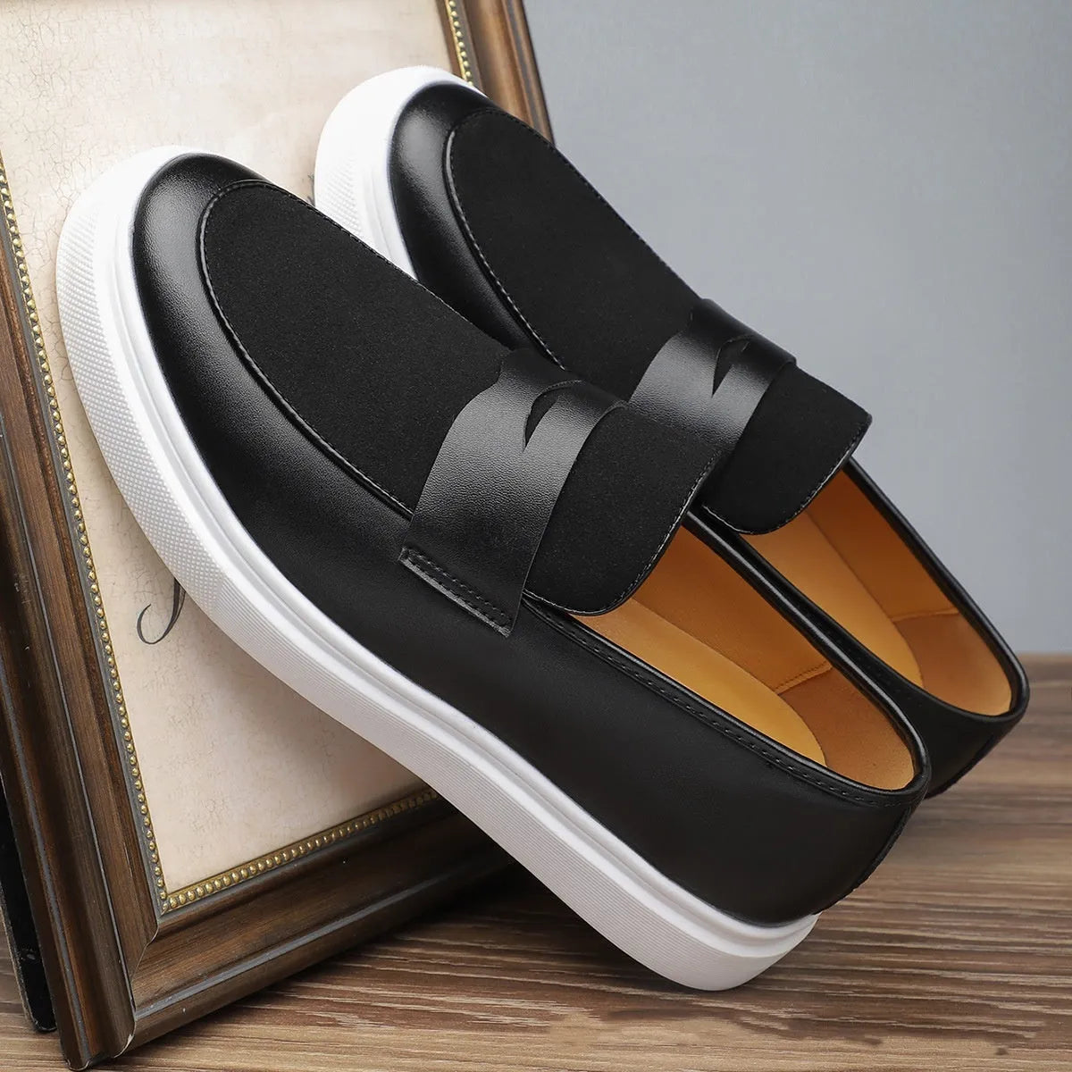 Black men's casual slip-on shoes with tassel detail and round toe on a gommino rubber sole