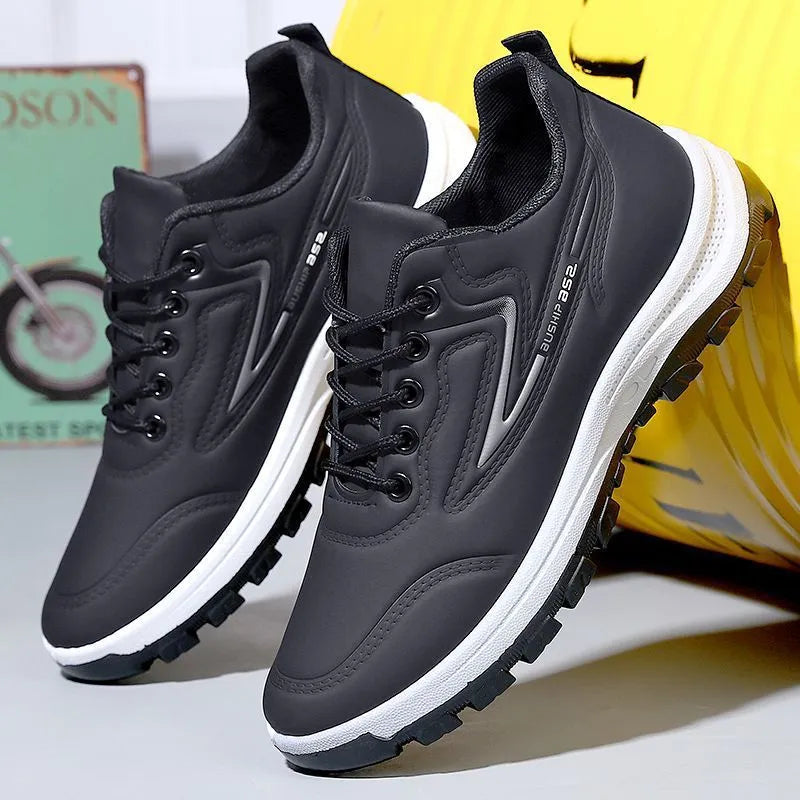 Black and grey waterproof leisure sports shoes with artificial PU upper and lace-up closure on a flat heel.
