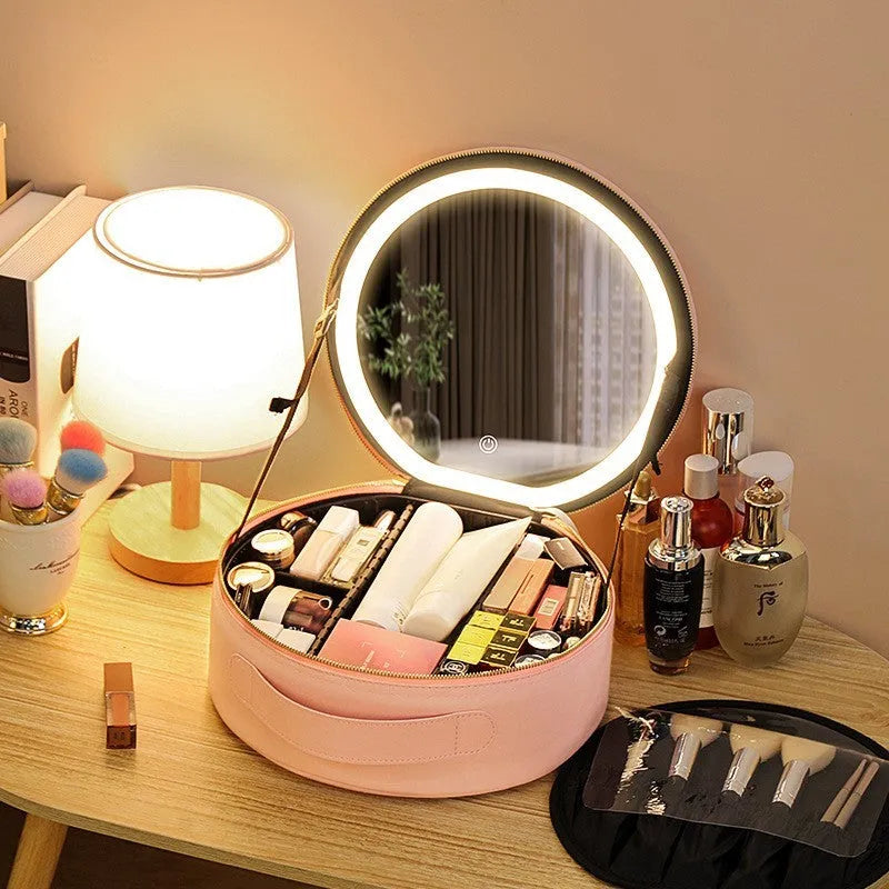 Round black PU leather makeup bag with open lid showing internal LED mirror and cosmetic partitions.